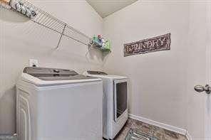 clothes washing area with washer and dryer