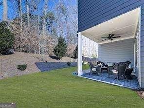 view of yard featuring ceiling fan and a patio area