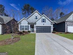 view of front of home with a garage and a front lawn