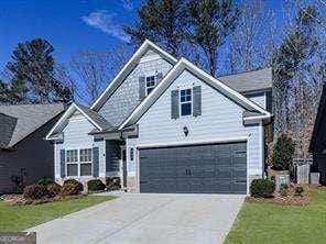 front of property with a garage and a front lawn