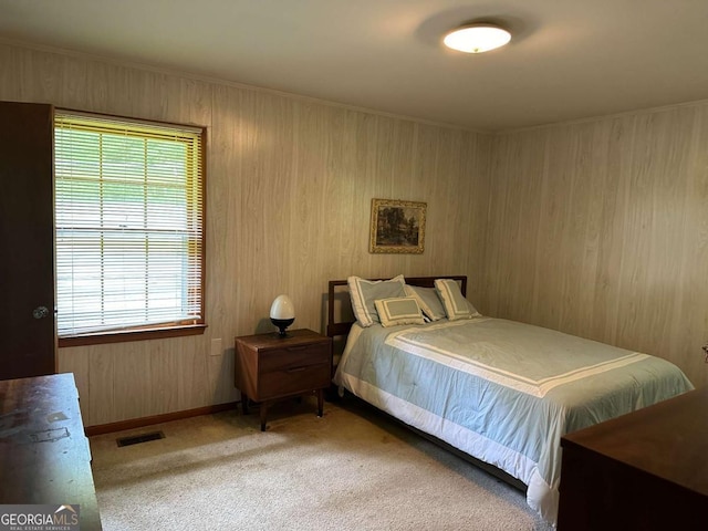 carpeted bedroom with wood walls