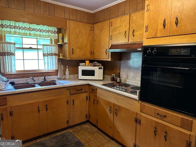 kitchen with ornamental molding, sink, cooktop, and black oven