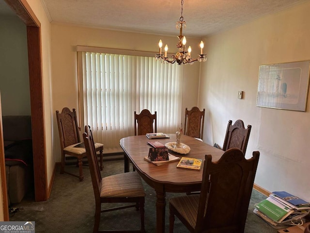 carpeted dining space featuring ornamental molding, a textured ceiling, and an inviting chandelier