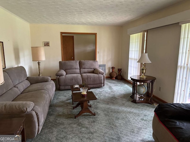 living room featuring dark colored carpet and a textured ceiling