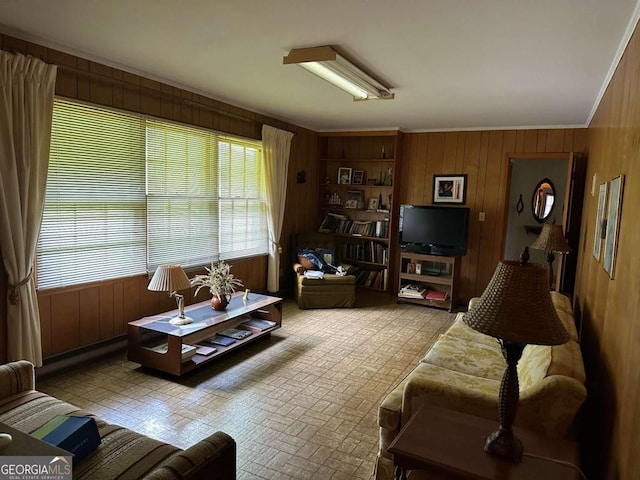 living room with crown molding and wooden walls