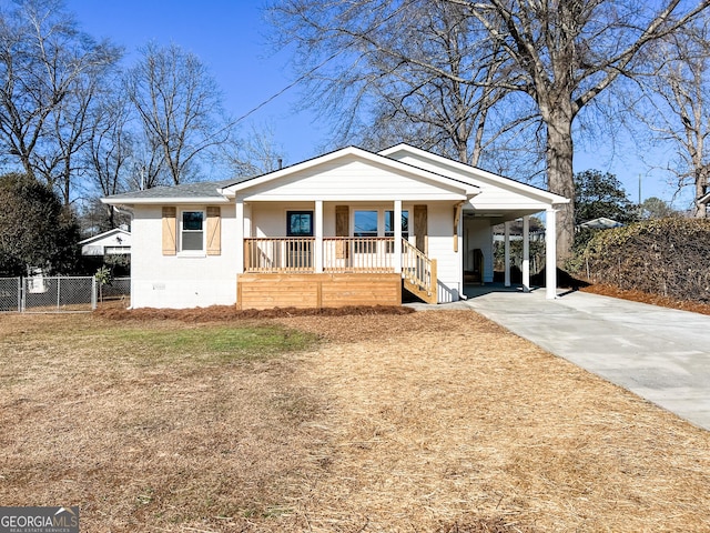 bungalow-style house with a carport, covered porch, and a front lawn