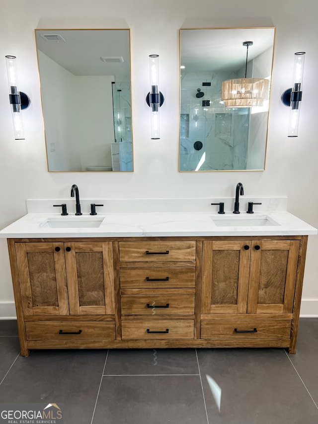 bathroom with tile patterned flooring, a shower, and vanity