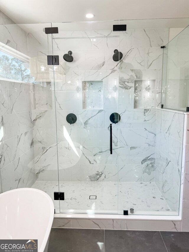 bathroom with separate shower and tub