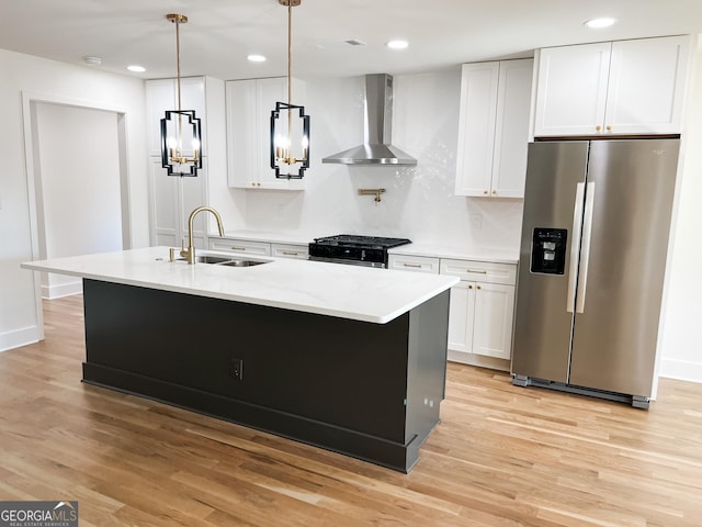 kitchen with stainless steel fridge with ice dispenser, wall chimney range hood, an island with sink, and white cabinets