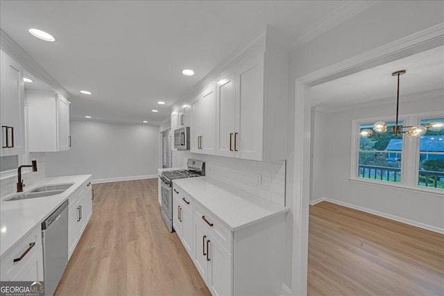 kitchen with sink, white cabinetry, stainless steel appliances, ornamental molding, and decorative backsplash