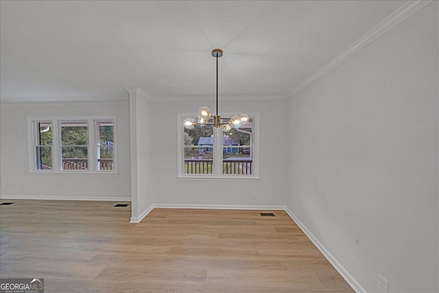 unfurnished dining area featuring ornamental molding, a chandelier, and light hardwood / wood-style flooring