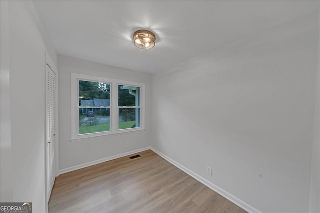 spare room featuring light hardwood / wood-style floors