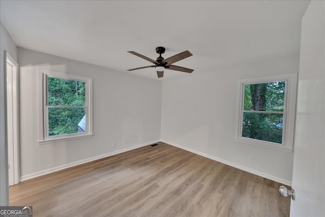 spare room with ceiling fan and light hardwood / wood-style flooring