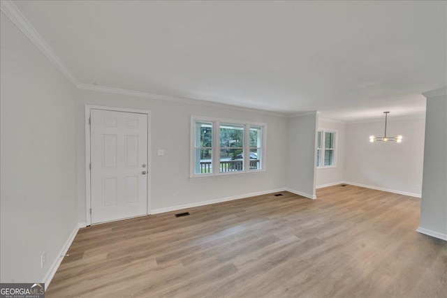 interior space with crown molding, a chandelier, and light hardwood / wood-style flooring