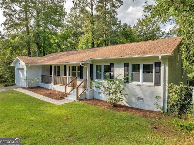 ranch-style home with a garage, a front yard, and covered porch