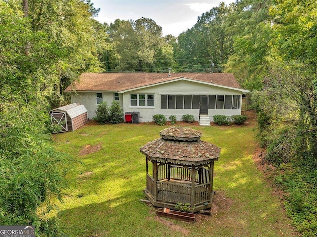 rear view of house with an outdoor structure and a yard