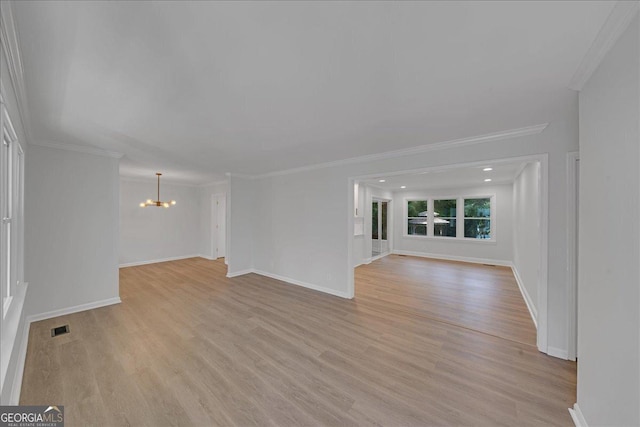 unfurnished living room with crown molding, a chandelier, and light hardwood / wood-style flooring