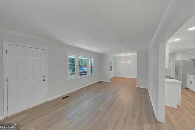 interior space with ornamental molding, light wood-type flooring, and a notable chandelier