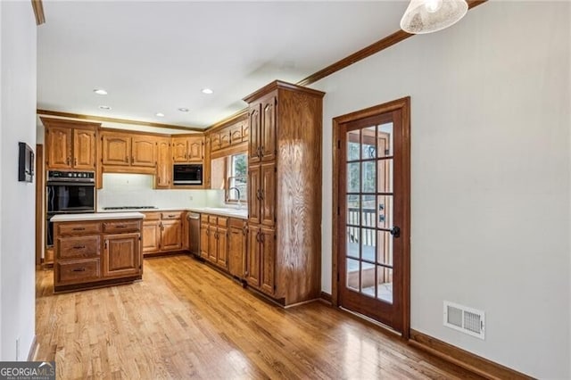 kitchen with sink, decorative backsplash, black appliances, crown molding, and light hardwood / wood-style flooring