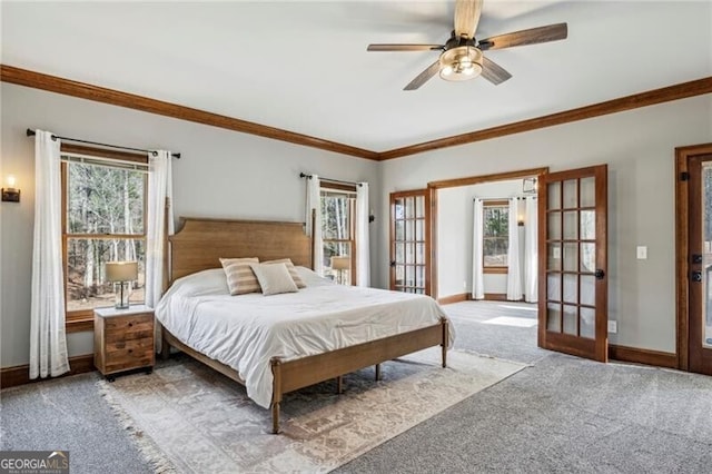 bedroom featuring crown molding, light colored carpet, multiple windows, and french doors