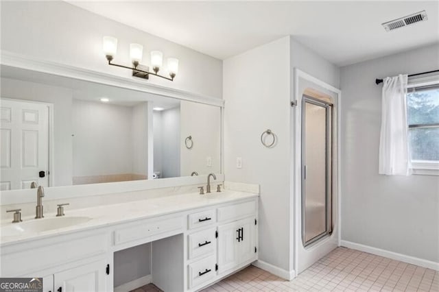 bathroom featuring vanity and a shower with door