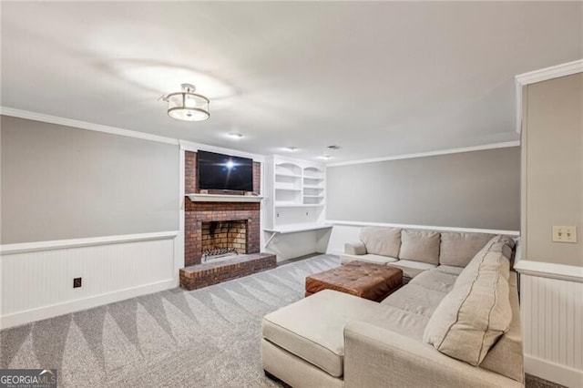 carpeted living room with built in shelves, a fireplace, and ornamental molding