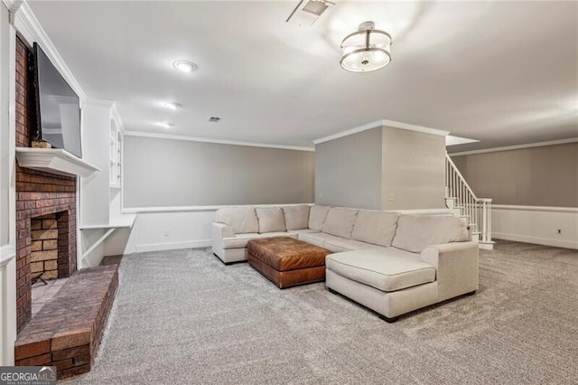 carpeted living room with ornamental molding and a brick fireplace