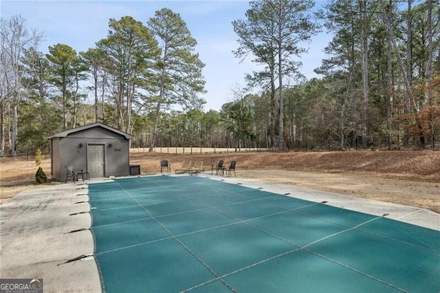 view of swimming pool with an outbuilding and a patio area