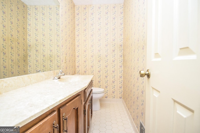 bathroom featuring tile patterned floors, toilet, and vanity