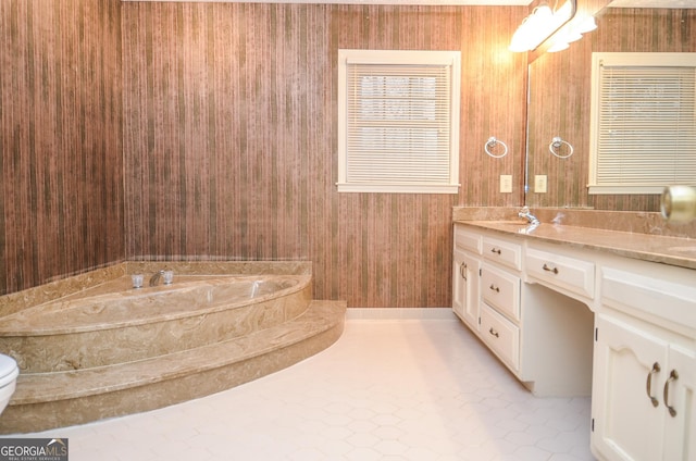 bathroom with tile patterned floors, vanity, and a bath