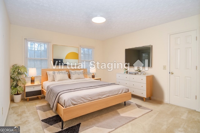 carpeted bedroom with a textured ceiling