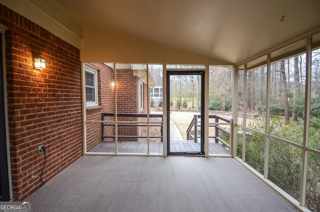 unfurnished sunroom with lofted ceiling and a healthy amount of sunlight