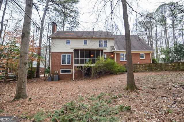 rear view of property featuring cooling unit and a sunroom