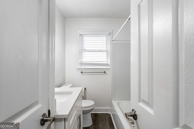 full bath with baseboards, vanity, toilet, and wood finished floors