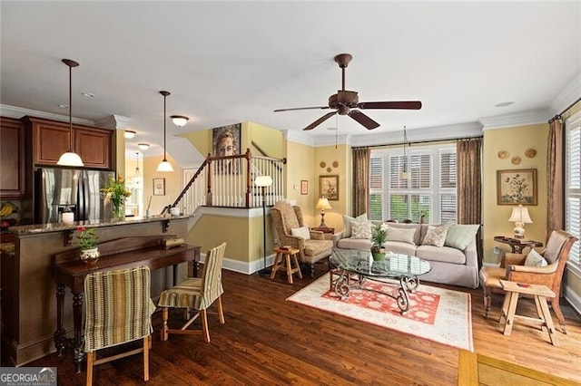 living room featuring crown molding, dark wood-type flooring, and ceiling fan