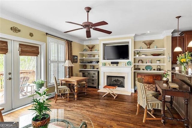 living room with ornamental molding, dark wood-type flooring, and ceiling fan