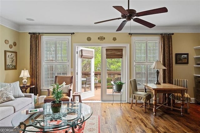 interior space featuring crown molding, plenty of natural light, hardwood / wood-style floors, and ceiling fan