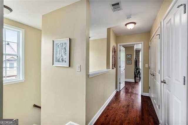 hallway with dark hardwood / wood-style flooring