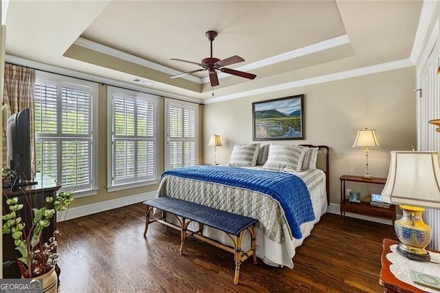 bedroom featuring crown molding, ceiling fan, dark hardwood / wood-style floors, and a raised ceiling