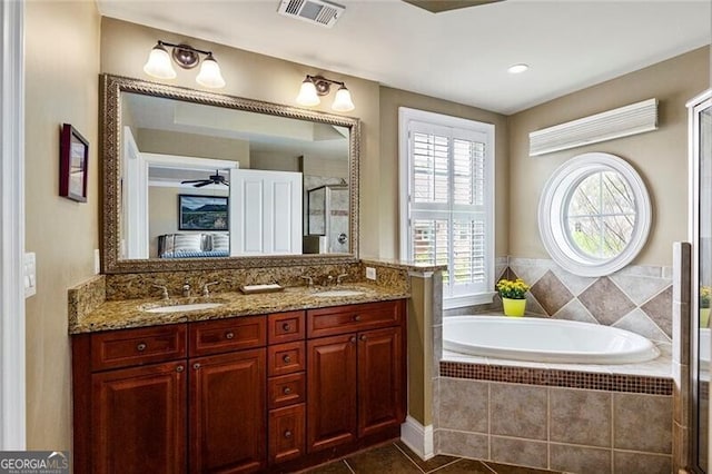 bathroom featuring vanity, tile patterned floors, ceiling fan, and plus walk in shower