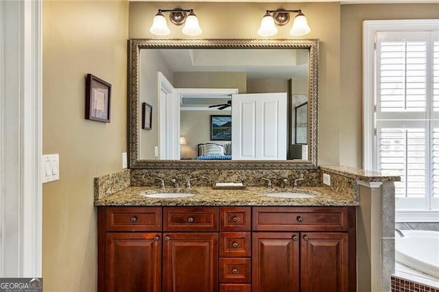 bathroom featuring vanity and a tub