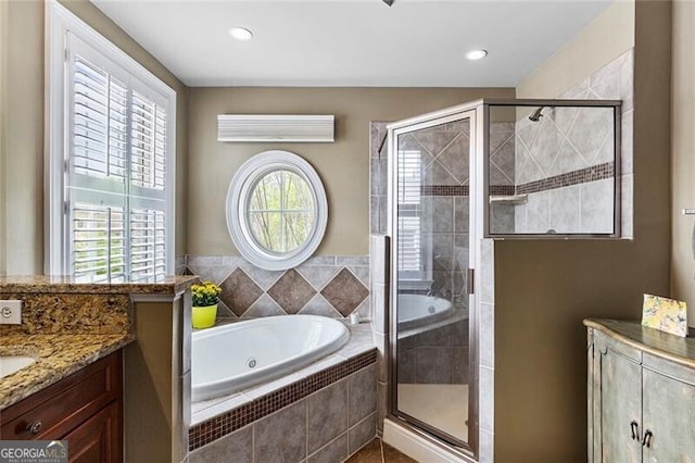 bathroom featuring vanity and separate shower and tub