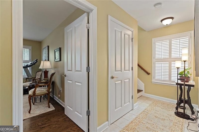 corridor featuring plenty of natural light and light tile patterned floors