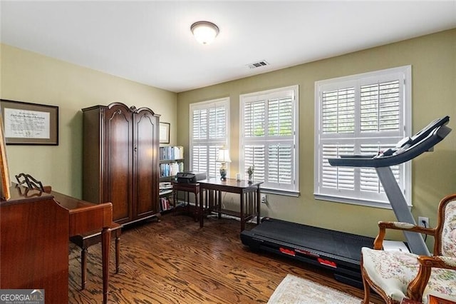 workout area with dark hardwood / wood-style floors