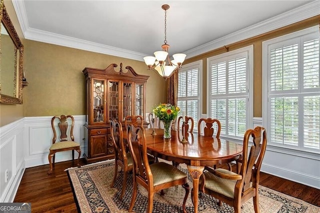 dining room featuring an inviting chandelier, dark hardwood / wood-style flooring, and crown molding