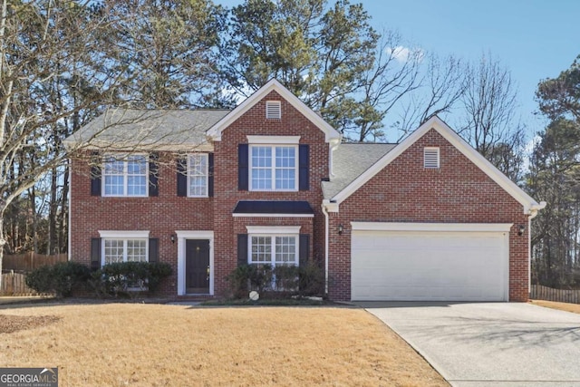 view of front of house featuring a garage and a front lawn