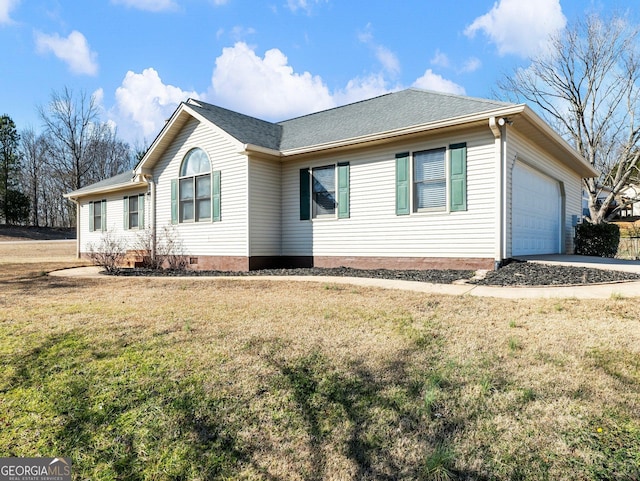 ranch-style house with a garage and a front lawn