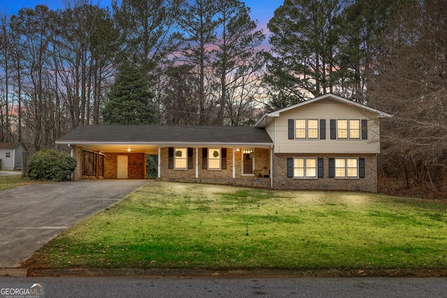 tri-level home with a carport and a lawn