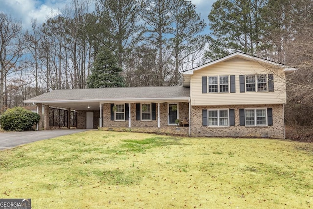 tri-level home featuring a carport and a front yard