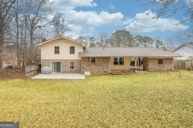 rear view of property featuring a yard and a patio area